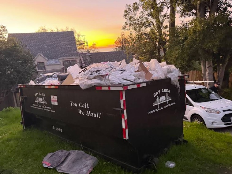 Bay Area Dumpster Rental and Junk Removal branded dumpster at dusk