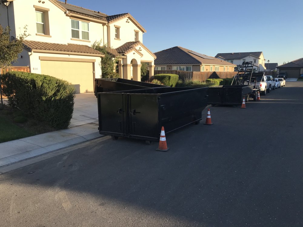 Two dumpsters staged on a residential street