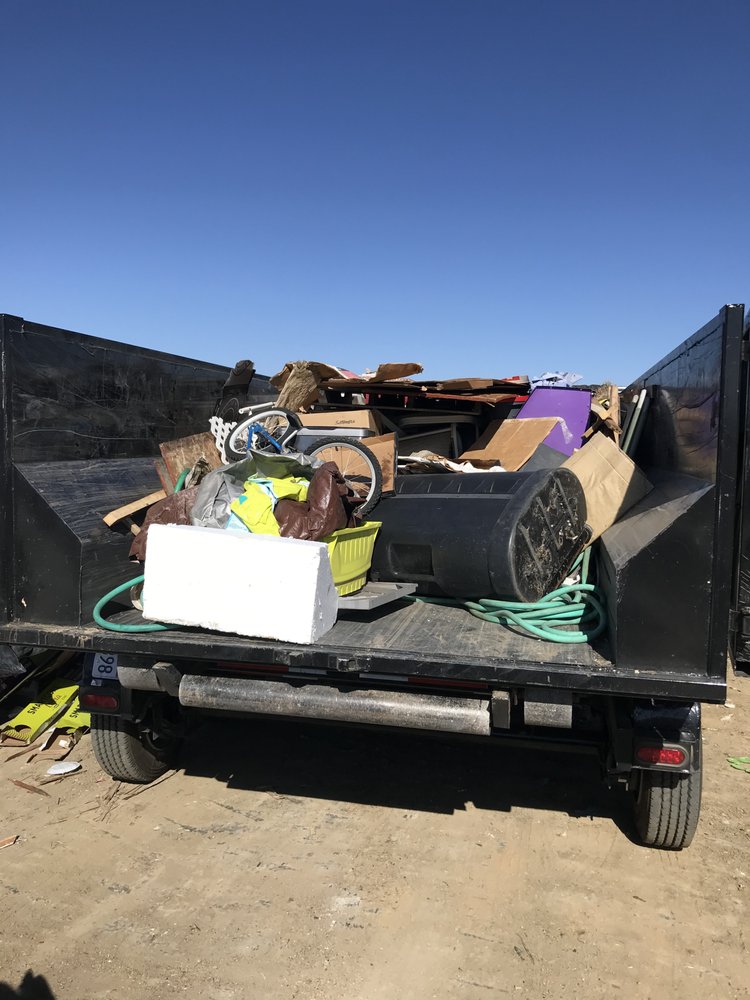 Truck bed loaded with residential junk ready for haul-away