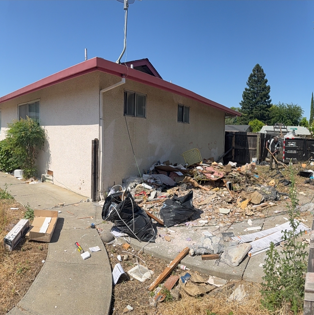 Side yard before cleanout, covered in construction debris